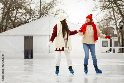 Happy female friends on ska...
