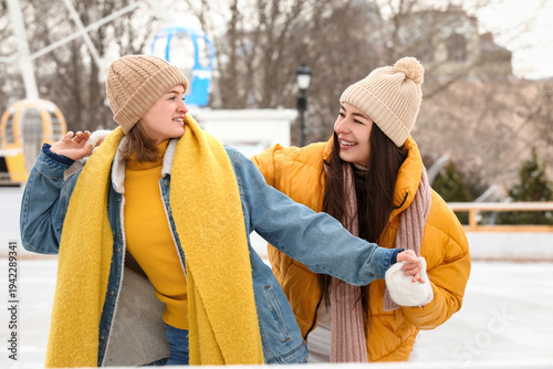 Female friends holding hand...