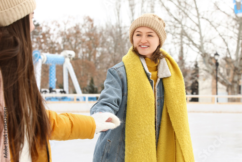 Female friends holding hand...