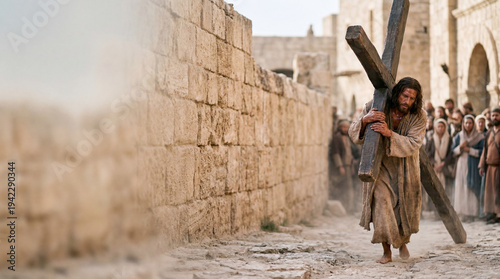 Jesus Christ carrying the wooden cross on the Way of the Cross with copy space.