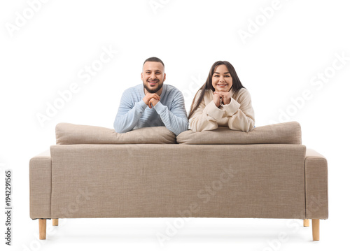 Young couple sitting on gre...
