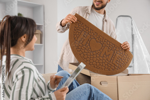 Young man with doormat and ...