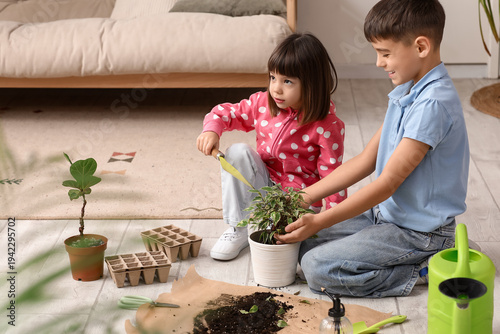 Little children repotting p...