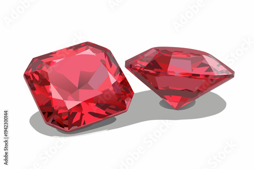 Two polished red ruby gemstones displayed on a reflective surface