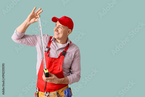 Male worker with tape measu...