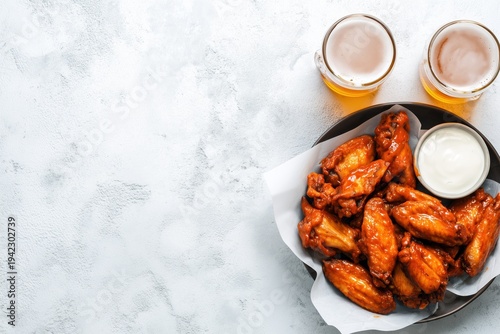 Buffalo style chicken wings served with cold beer, top view with copy space 