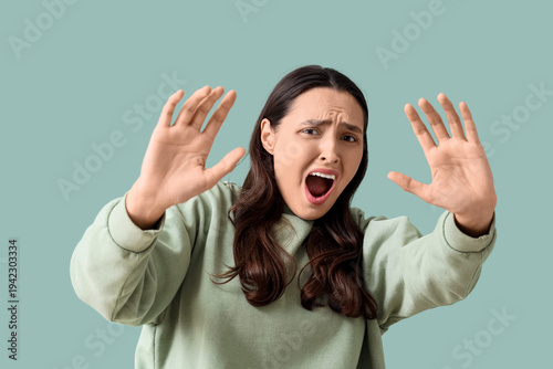 Scared young woman screamin...