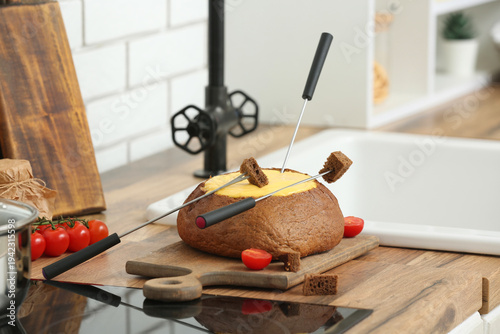 Cheese fondue in bread, sti...