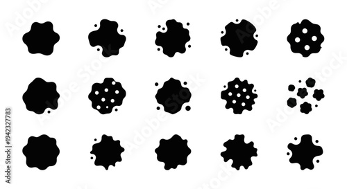 Collection of abstract black splatters and blots in various shapes on a clean surface viewed directly from above