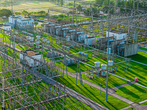 Modern high-voltage electrical substation and power transmission towers for electricity distribution.