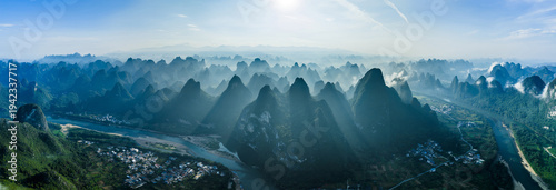 Aerial view of the Li River and iconic karst mountains shrouded in morning mist in Yangshuo, Guilin, China.