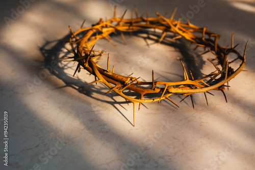 the crown of thorns of Jesus on  marble floor background against  window light with copy space, can be used for Christian background, Easter concept