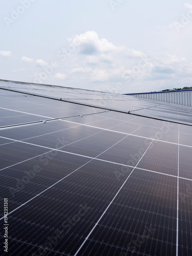 Solar panels installed on industrial warehouse roof generating renewable energy