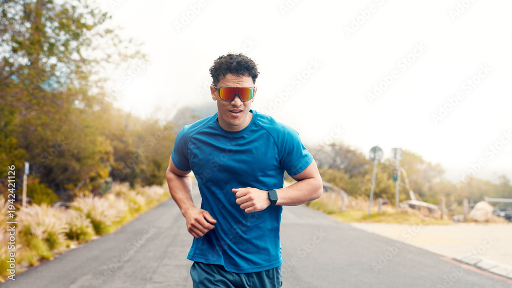 Fototapeta premium Fitness, running or man with sunglasses, outdoor or training for health benefits, cardio or workout. Nature, runner or person in street, eyewear or practice for wellness or shades for uv protection
