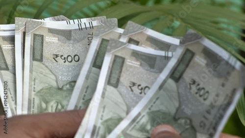 Close up of hand counting Indian five hundred rupee notes. Macro shot of the Reserve Bank of India 500 rupee note details. Indian Rupees counting. Indian currency View. 