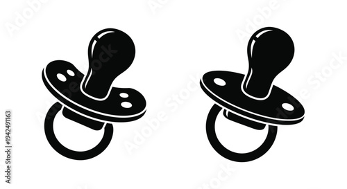 Two black pacifiers depicted in a stark modern silhouette