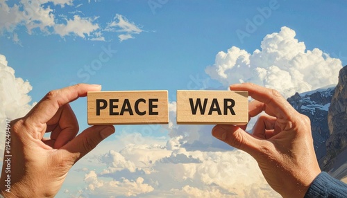 Two hands holding wooden blocks labeled PEACE and WAR against a blue sky with clouds, with PEACE above WAR, symbolizing peace prevailing over conflict, harmony, and the triumph of nonviolence.
