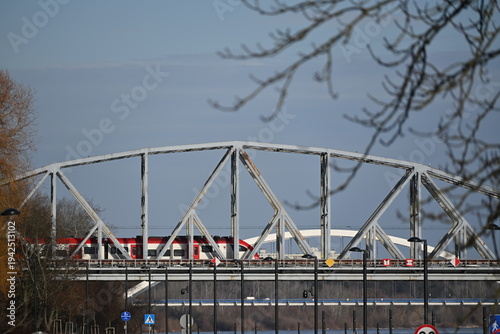 Tableau sur toile Modern Passenger Train Crossing Steel Arch Bridge Over Vistula River in Poland