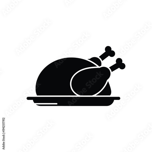 A roasted turkey centered on a platter viewed from the side on a clean white surface