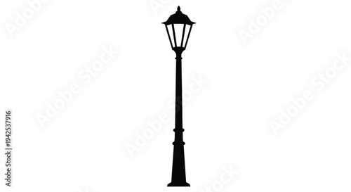A solitary black silhouette of a vintage street lamp post
