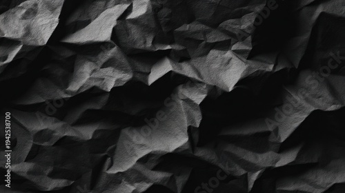 Abstract monochrome wrinkled paper texture background with irregular folds
