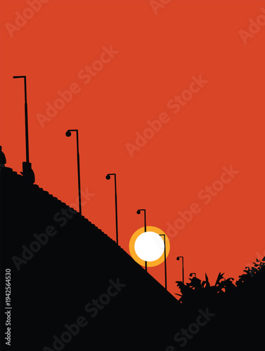 An urban sunset, silhouette of a city   glows against an orange dusk sky as the sun sets behind building construction and industrial clouds during a vibrant evening