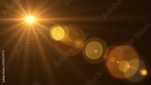 Golden light flare with lens effects on dark background