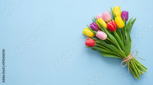 Vibrant Tulips Bouquet: A colorful array of tulips in full bloom, tied with rustic twine against a serene backdrop, evoking a sense of spring and freshness.