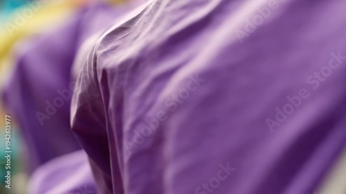 Abstract purple fabric flowing with blurred colors in the background