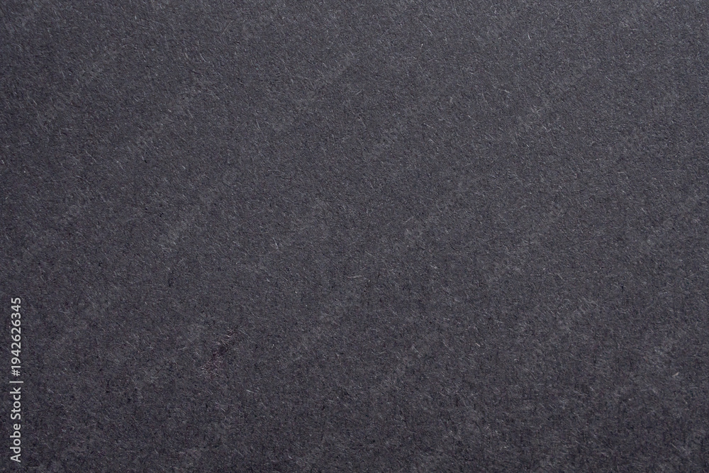 Fototapeta premium Black paper texture background with rough fiber surface and dark grey cardboard pattern