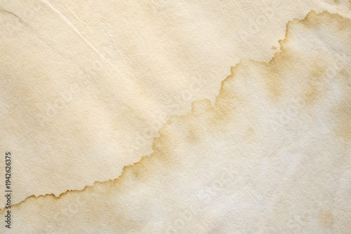 Old vintage paper texture background with aged stains and antique yellowed parchment effect