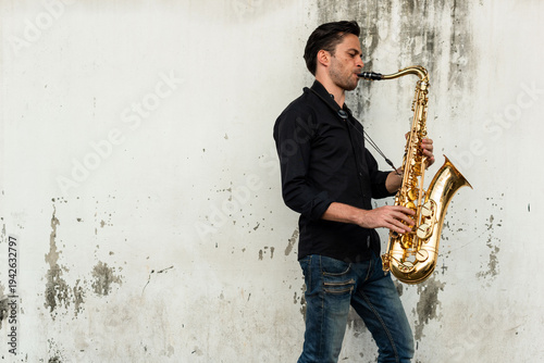 Canvas Print Man playing saxophone outdoors.
