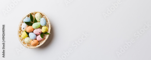 Wallpaper Mural Colorful Easter eggs in wicker basket against colored background, closeup. top view with copy space Torontodigital.ca