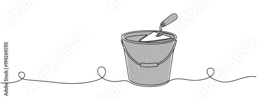 Paint bucket with trowel resting on white minimal background