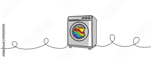 Washing machine with colorful clothes in spinning cycle setting