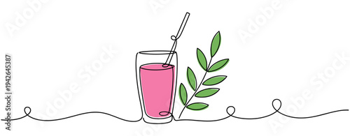 Glass with pink drink beside green leaf on white background