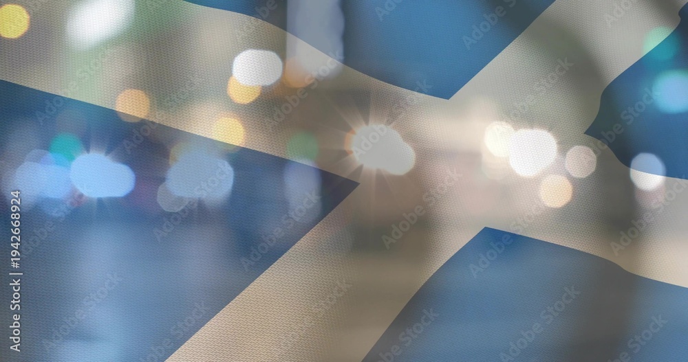Fototapeta premium Displaying Saltire flag showing woven texture at night, with bokeh lights and lens flares