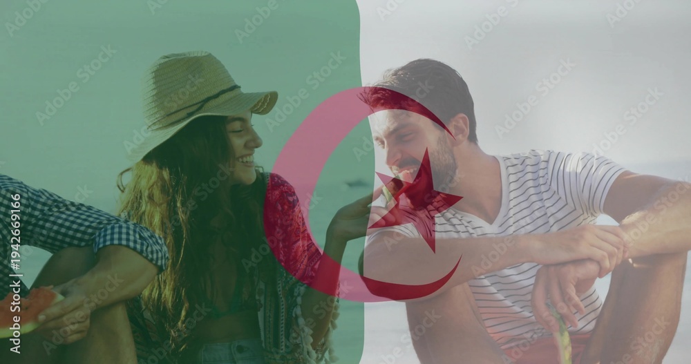 Obraz premium Sharing trio passing watermelon at beach wearing straw-hat patterned-wrap striped-tee Algerian flag