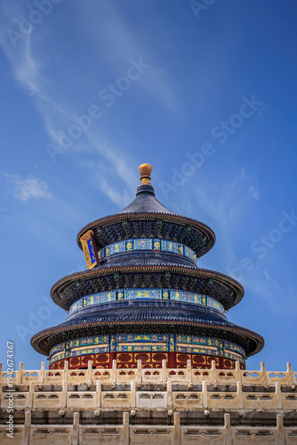 Side view of the Hall of Prayer for Good Harvests at the Temple of Heaven in Beijing, China, showcasing traditional Chinese architecture under a clear blue sky.