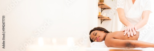 Εκτύπωση καμβά A person receiving a relaxing massage in a serene spa setting