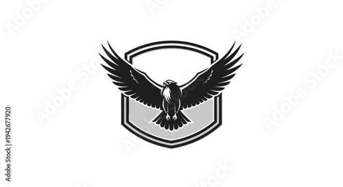 Majestic black and white eagle bird of prey emblem with outstretched wings within a shield, powerful graphic illustration