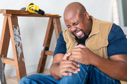 Injured worker holding knee painfully