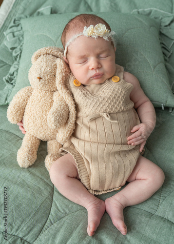 Baby care comfort shown through newborn sleeping peacefully on soft bedding