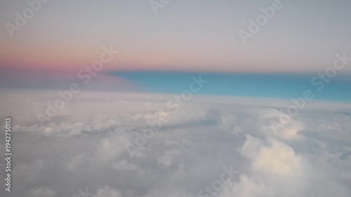Cinematic Aerial View of Fluffy White Clouds Moving Past Airplane Window at High Altitude