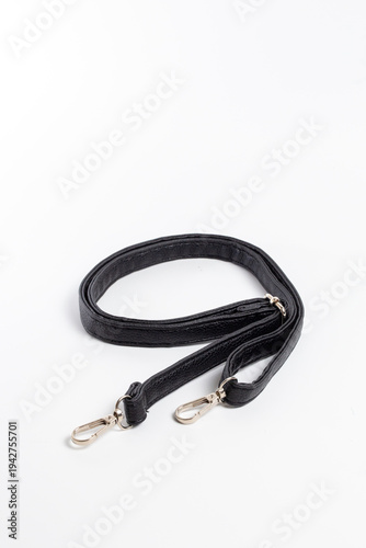 Konstfotografi Top view of black nylon bag strap with two gold-tone carabiners