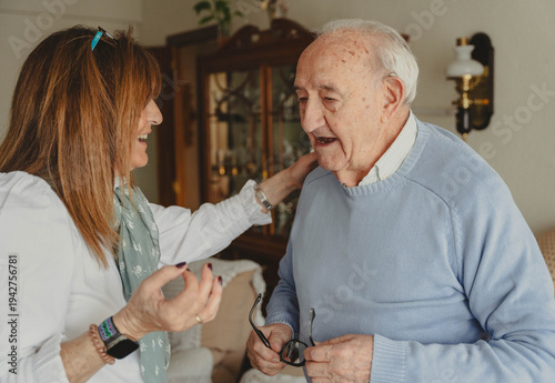 Принти на полотні Daughter caring for senior father in living room