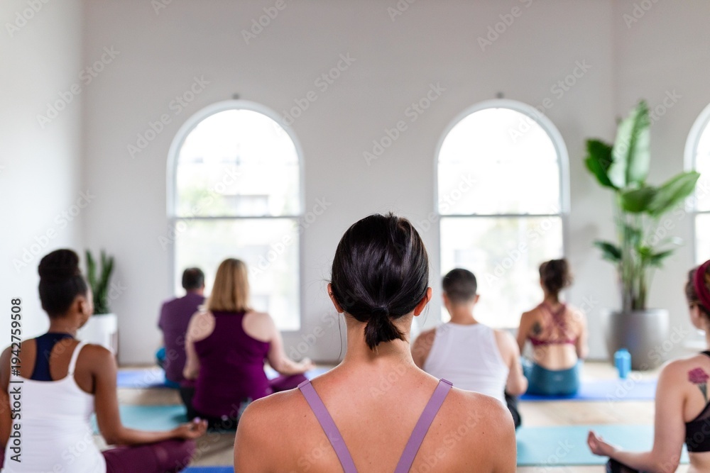 Fototapeta premium Group meditation in serene studio.