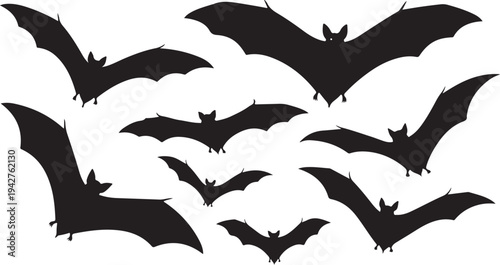 Black bat silhouettes flying in various directions together