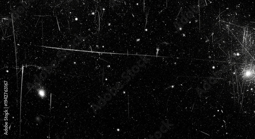 Dark cinematic background with prominent white scratches on the edges and scattered dust particles for a retro film aesthetic.