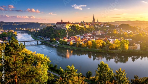 A scenic panoramic view of a river cutting through a city with medieval structures, basking in warm sunset light